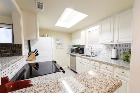 Gourmet kitchen with granite countertops and newly tiled backsplash.