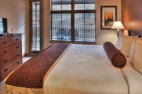 King size bed and plenty of room in private bedroom. Door out to Deck area.