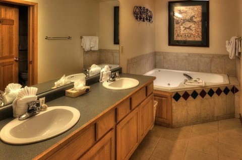 his/her vanities in master bath and jetted soaking tub