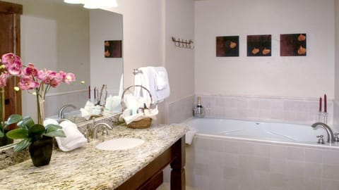 Master bath has two sinks and a soaking jetted tub.  there is a guest bath also