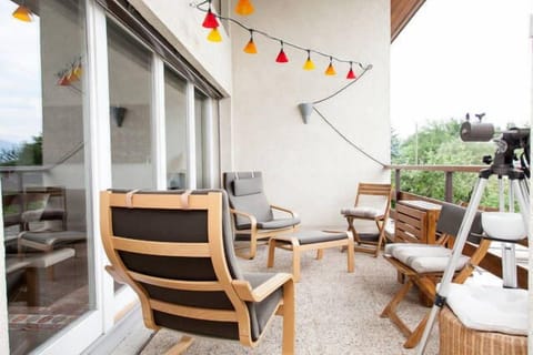The balcony, with relaxing chairs and a table for ouside meals