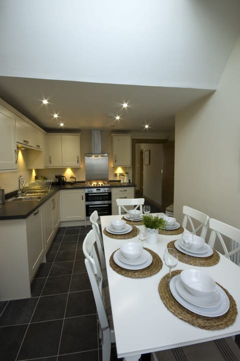 Fully fitted kitchen  with dining table leading off to sun-room