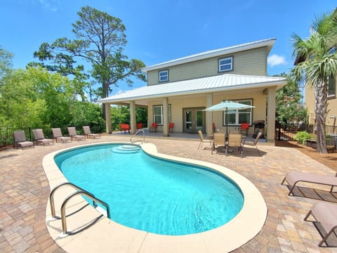 Back of Destin Sun with a Wrap Around Style Covered Back Porch! Lots of Seating! Large Private Saltwater Pool! Lounge Chairs! 2 Outdoor Dining Areas! Grill! A Backyard for the Whole Family to Enjoy!