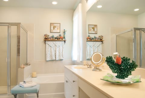 Double sinks, oval tub, shower, make up space, with full length mirror 