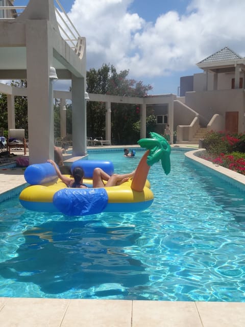Relax on a float while other guests enjoy playing in the shallow end 