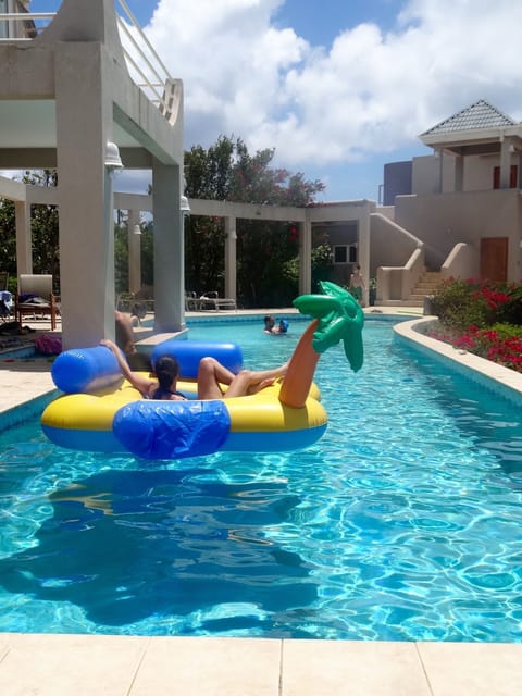 Relax on a float while your children enjoy playing in the shallow end 