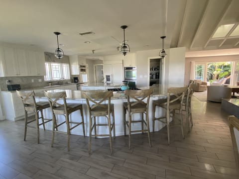The open layout of the kitchen flows straight into the living and dining areas.