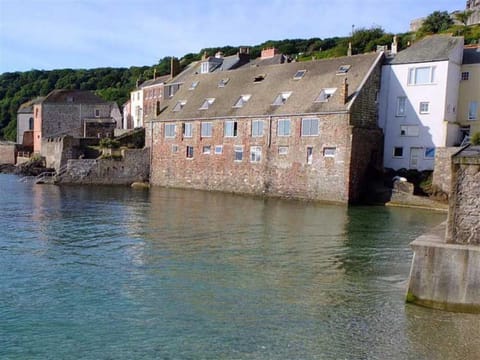 View of cottage from beach with tide in