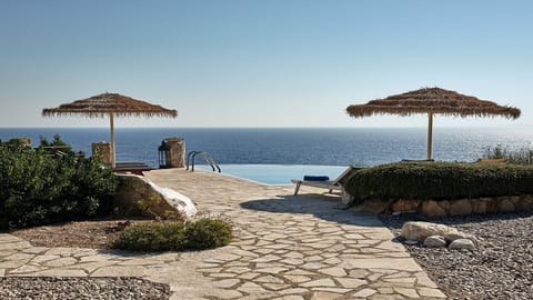 An infinity pool, sun loungers