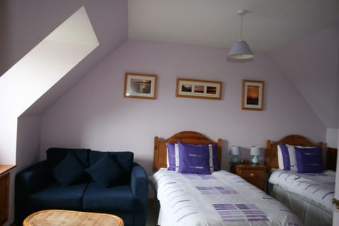The upstairs twin bedroom with seating area