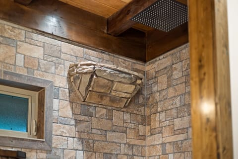 Waterfall and rainfall shower heads in the walk in shower.