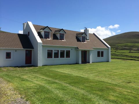 The house is surrounded by grass