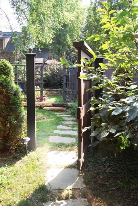 A stone path winding through the Studio's garden leads to its private entrance.