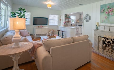 Living room and kitchen are separated by a bar area