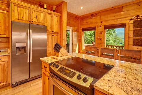 side view of island with built in oven and stove and side view of refrigerator