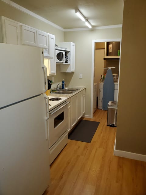 Full kitchen with adjacent utility room with full size washer and dryer