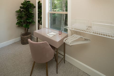 Master walk-in closet has work friendly desk.