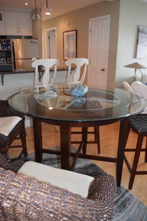 The dining table seats four with additional seating for 2 more at the bar.