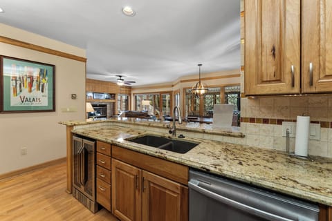 Full kitchen featuring stainless steel appliances, including a wine fridge.