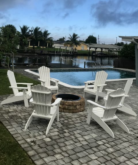 Fire pit with 6 chairs overlooking Banana River