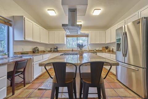 This kitchen was made for cooking and entertaining with a gas stove and granite counters