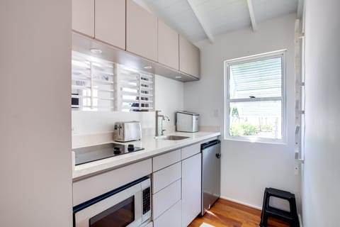 kitchenette fully equipped with microwave, toaster, ice maker, stove top etc.