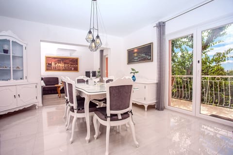 Dining and living area with A/C, balcony and sea views