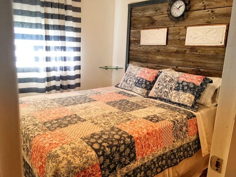 Master bedroom features a headboard made from barn board hewn 70 years ago.