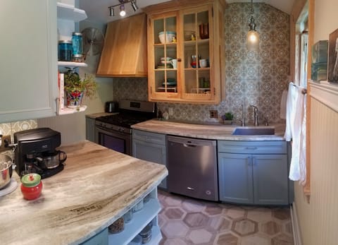 The compact chefs kitchen comes fully equipped, and has natural stone counters!