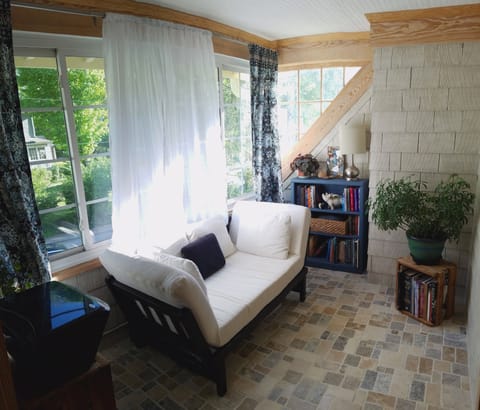 The sun porch is the perfect spot to read with tons of light and fresh air.