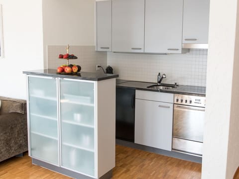 Flooring, Kitchen, Countertop, Cabinetry, Kitchen Appliance, Furniture, Floor, Wood, Interior Design, Major Appliance