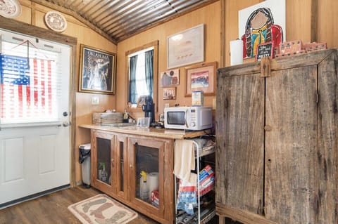 A kitchenette including a microwave, mini-fridge, coffee maker, and hot plate provide your basic culinary needs.