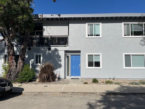 Exterior of building showing apartment above and lower unit entrance.