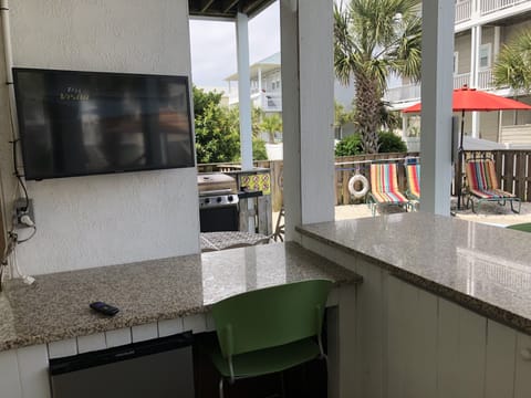 Outdoor HDTV with pool bar and fridge underneath