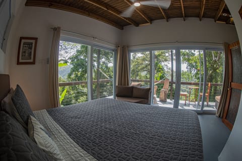 The comfort of a king sized bed with a tree house view.