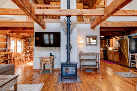 View of great room, kitchen, and loft with electric fireplace.