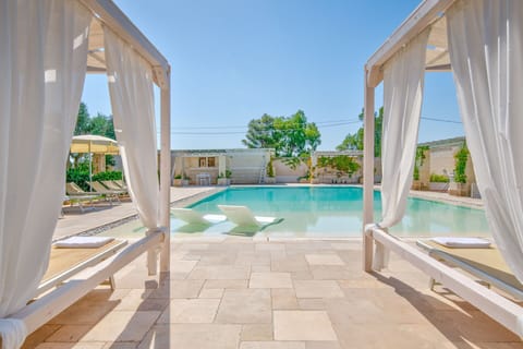 A heated pool, sun loungers