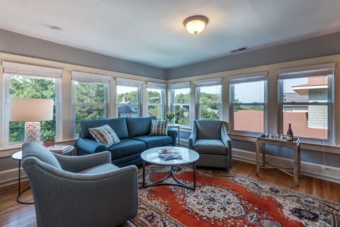 Spacious living room with large TV and lots of natural light