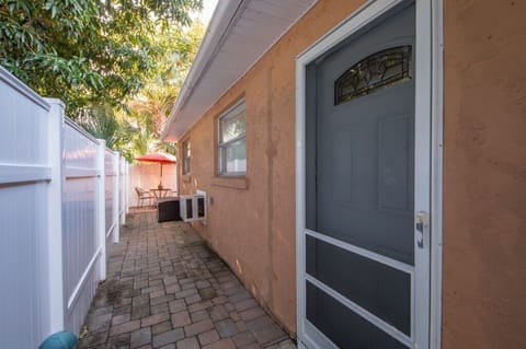 Front door is behind fence, left side of house