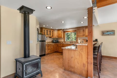 View into the kitchen after entering the cabin (stove is a hearthstone)