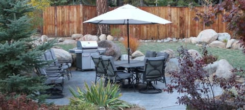 Separate outdoor BBQ and patio area with multiple chairs and spacious seating