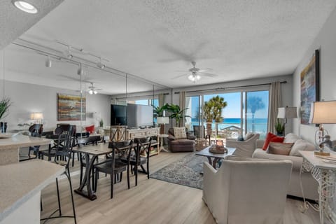 Spacious living and dining area overlooking the beach and theGulf of Mexico