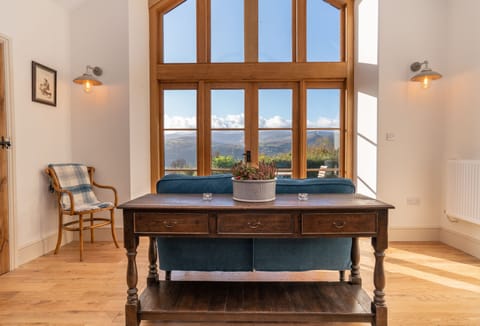 Split level ground floor: Sitting room with stunning rural views and a wood burning stove