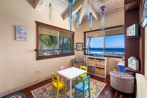 Whimsical kids’ playroom with ocean views, custom art, and creative space for imagination to flourish.