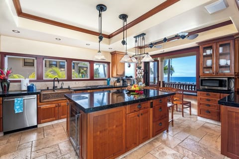 Gourmet kitchen with Bosch appliances, center island, and bar seating—ideal for group cooking or chef service.