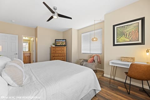 Spacious master bedroom with king bed, private work area with monitor, reading nook, attached bath and walk-in closet.
