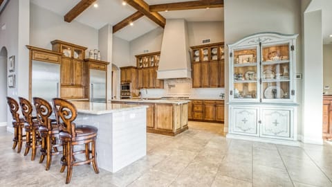 Immaculate large kitchen w/ double fridge & two islands w/ counter seating.