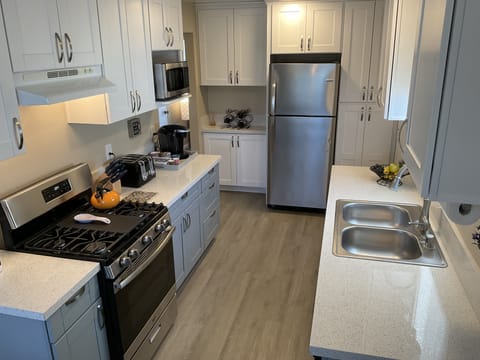 Remodeled kitchen with new stainless steel appliances, microwave, keurig