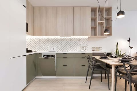 Kitchenette with plenty of kitchen utensils and dishes. 