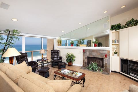 Light and bright oceanfront living room with fireplace